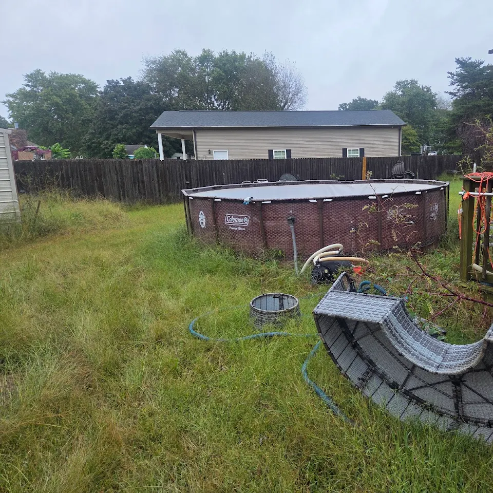 Above-ground pool and backyard debris ready for removal Above-ground pool and backyard debris ready for removal