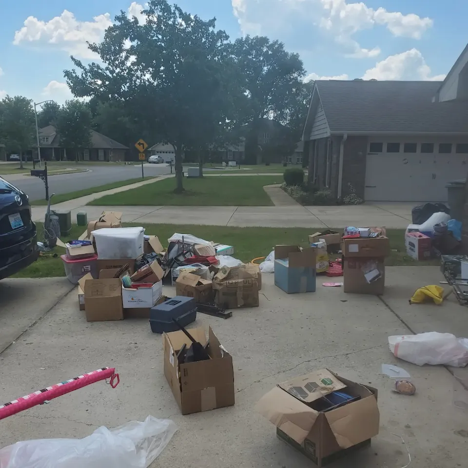 Boxes and household items in a driveway ready for removal