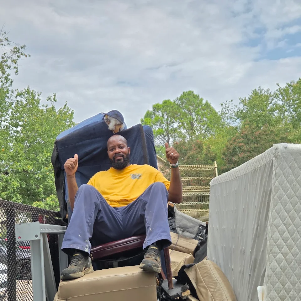 Haul Of Fame crew member on a recliner loaded on the trailer with a mattress Haul Of Fame crew member on a recliner loaded on the trailer with a mattress