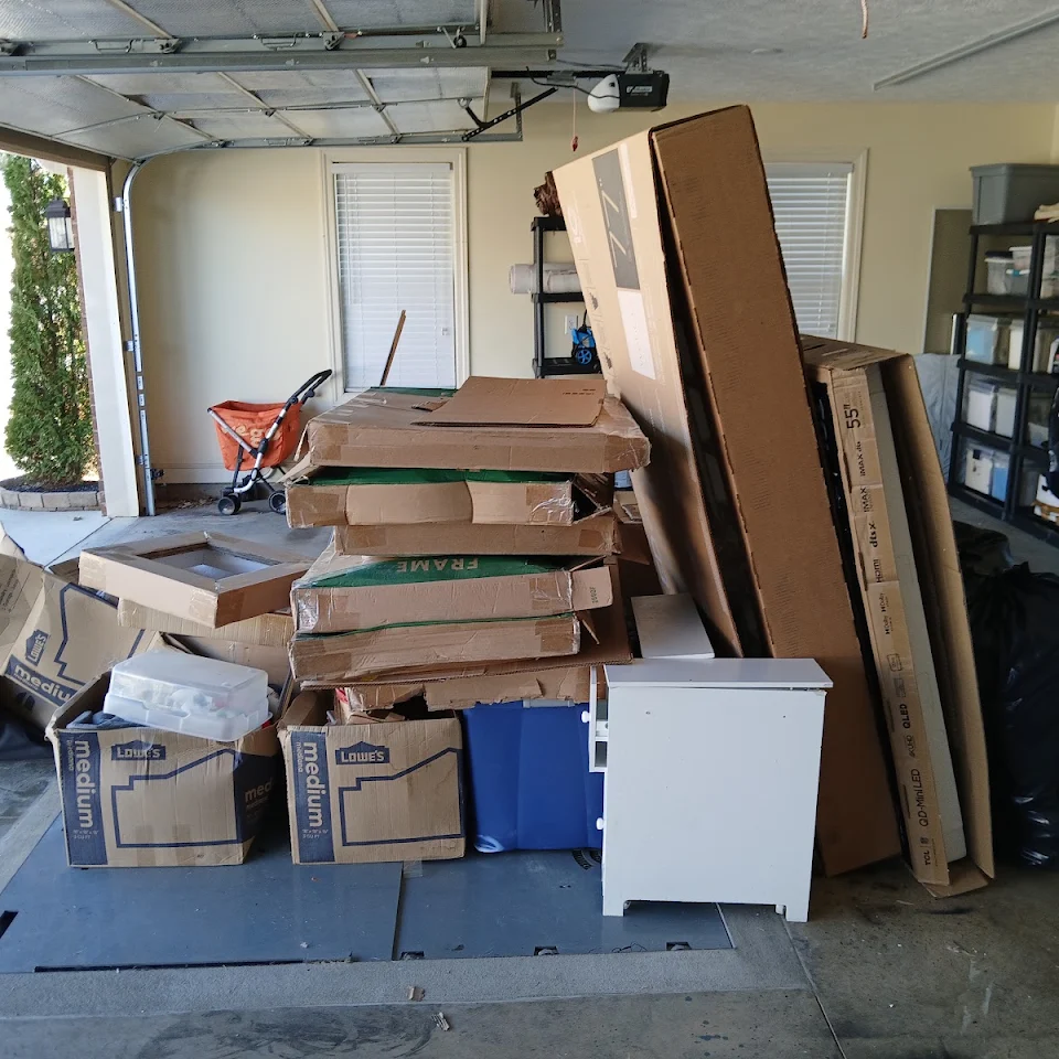 Garage packed with furniture and boxes before a cleanout Garage packed with furniture and boxes before a cleanout