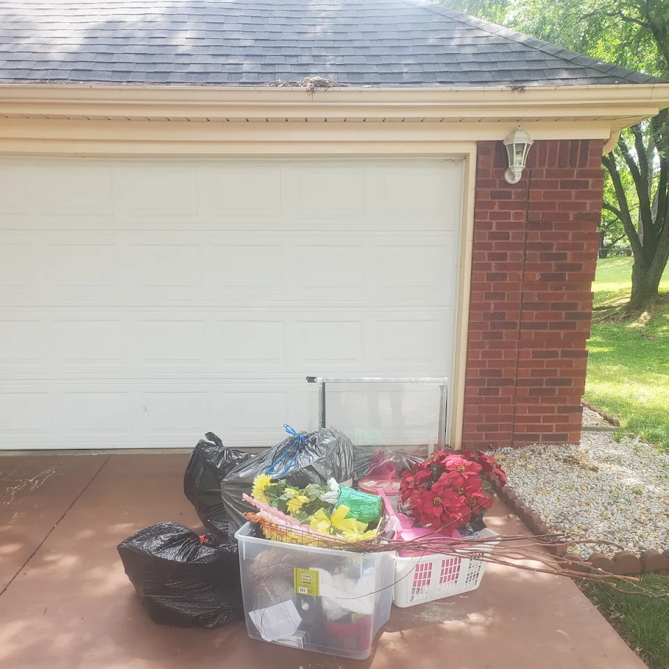 Household items set out in front of a garage for removal Household items set out in front of a garage for removal