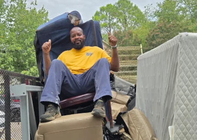 Haul Of Fame crew member on a recliner loaded on the trailer - Huntsville area junk removal