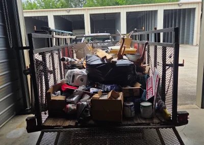 Trailer loaded with household junk at a storage facility - Huntsville area junk removal