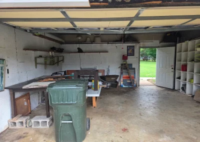Garage with junk before a cleanout - Huntsville area junk removal