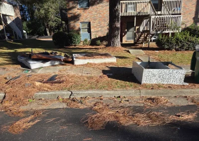 Yard debris and junk behind an apartment building - Huntsville area junk removal