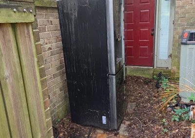 Old cabinet next to a house for removal - Huntsville area junk removal
