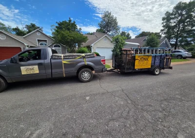 Haul Of Fame truck and trailer on a residential street - Huntsville area junk removal