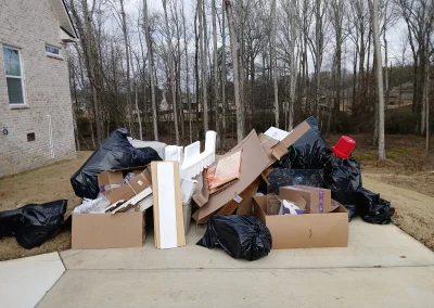 Bags, boxes and debris piled for pickup - Huntsville area junk removal