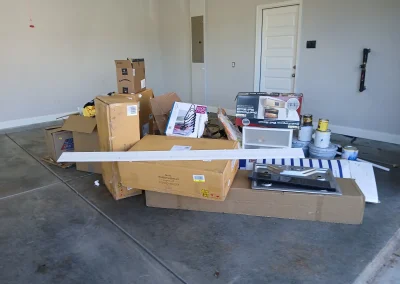 Boxes and office items in a garage for removal - Huntsville area junk removal