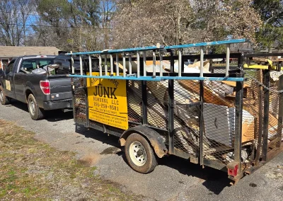 Haul Of Fame truck and loaded trailer at a job - Huntsville area junk removal