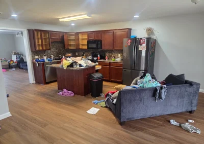 Kitchen and living room with junk before a cleanout - Huntsville area junk removal