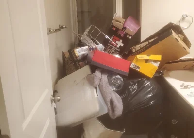 Cluttered room before a cleanout - Huntsville area junk removal