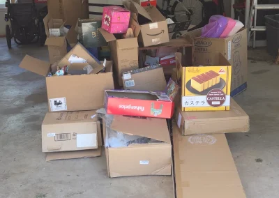 Boxes piled in a garage for removal - Huntsville area junk removal