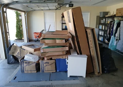 Garage packed with furniture and boxes - Huntsville area junk removal
