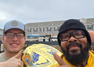 Haul Of Fame crew with the championship belt - Huntsville area junk removal