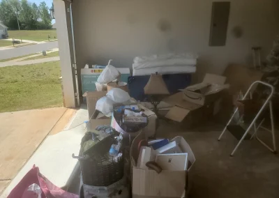 Room with boxes and junk before a cleanout - Huntsville area junk removal