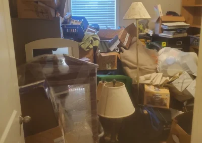 Cluttered room before Haul Of Fame junk removal - Huntsville area junk removal