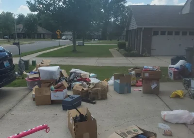 Boxes and household items in a driveway - Huntsville area junk removal
