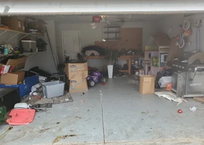 Cluttered garage before a cleanout - Huntsville area junk removal