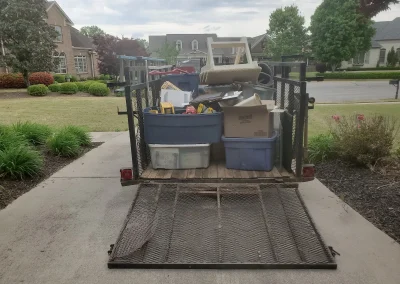 Trailer loaded with bins and household items - Huntsville area junk removal