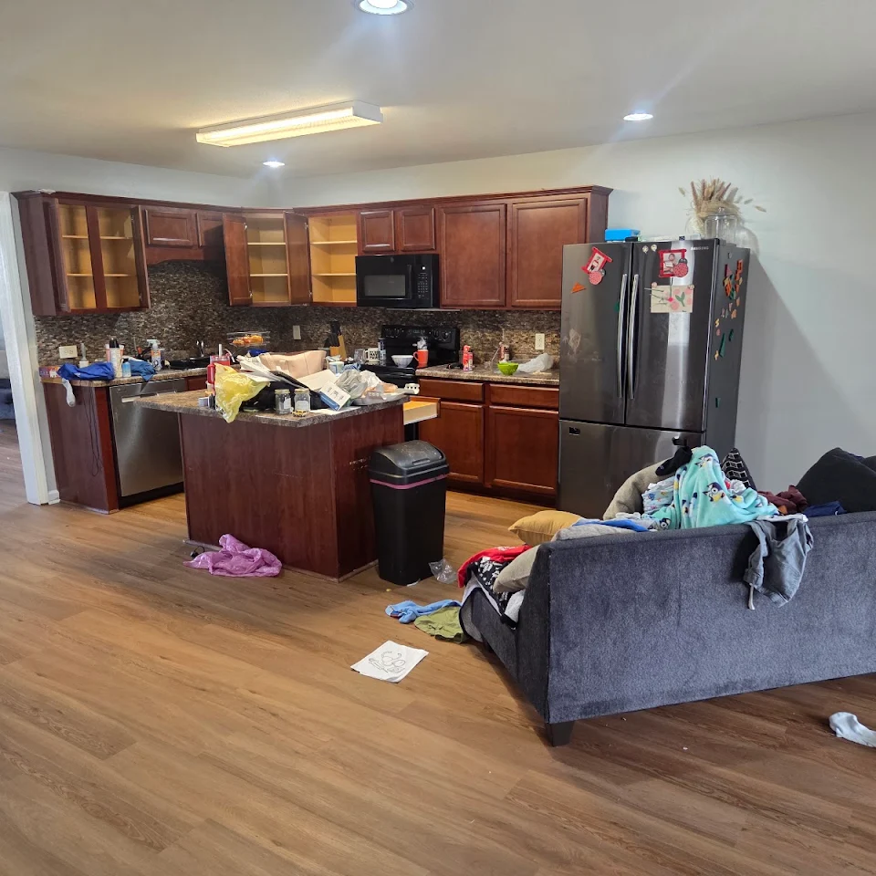 Kitchen and living room with junk before an apartment cleanout Kitchen and living room with junk before an apartment cleanout