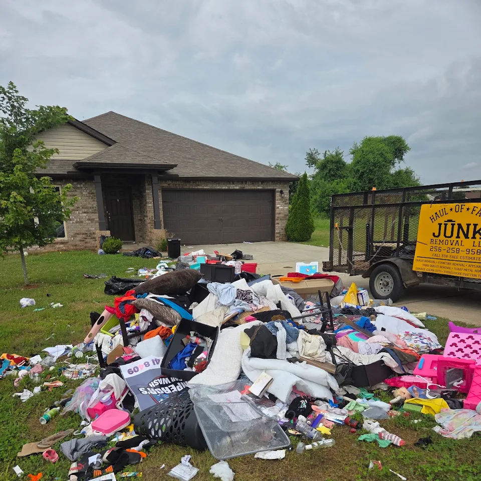 Large pile of household trash left in a front yard before a trashout Large pile of household trash left in a front yard before a trashout