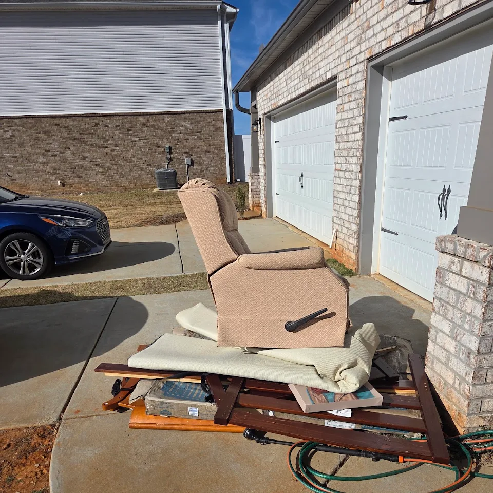 Old recliner and bulky furniture in a driveway ready for pickup Old recliner and bulky furniture in a driveway ready for pickup