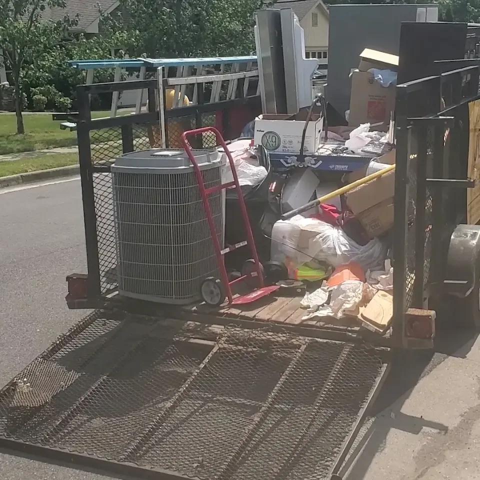 Trailer loaded with household junk on a North Alabama job